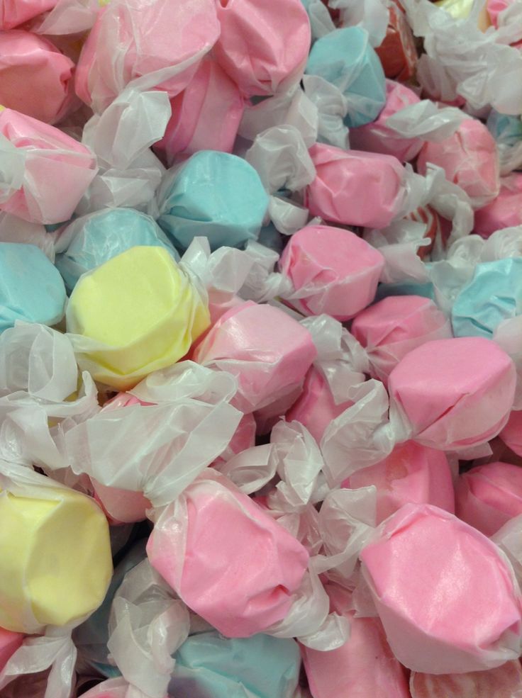 colorful marshmallows are piled on top of each other in plastic wrappers