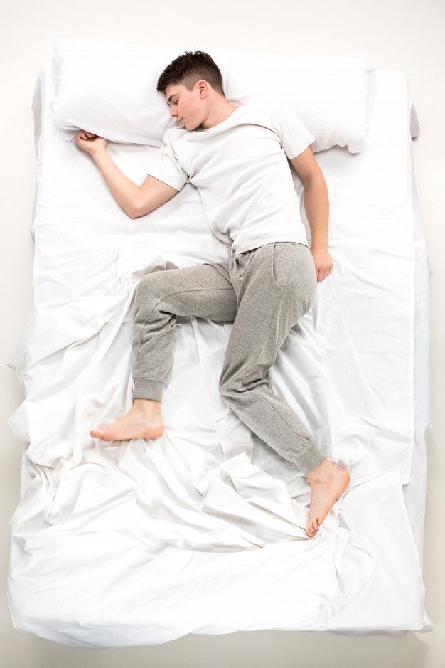 a man laying in bed with his feet up on the pillow royalty images and stock photos