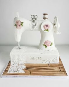 a white sewing machine with pink roses on it