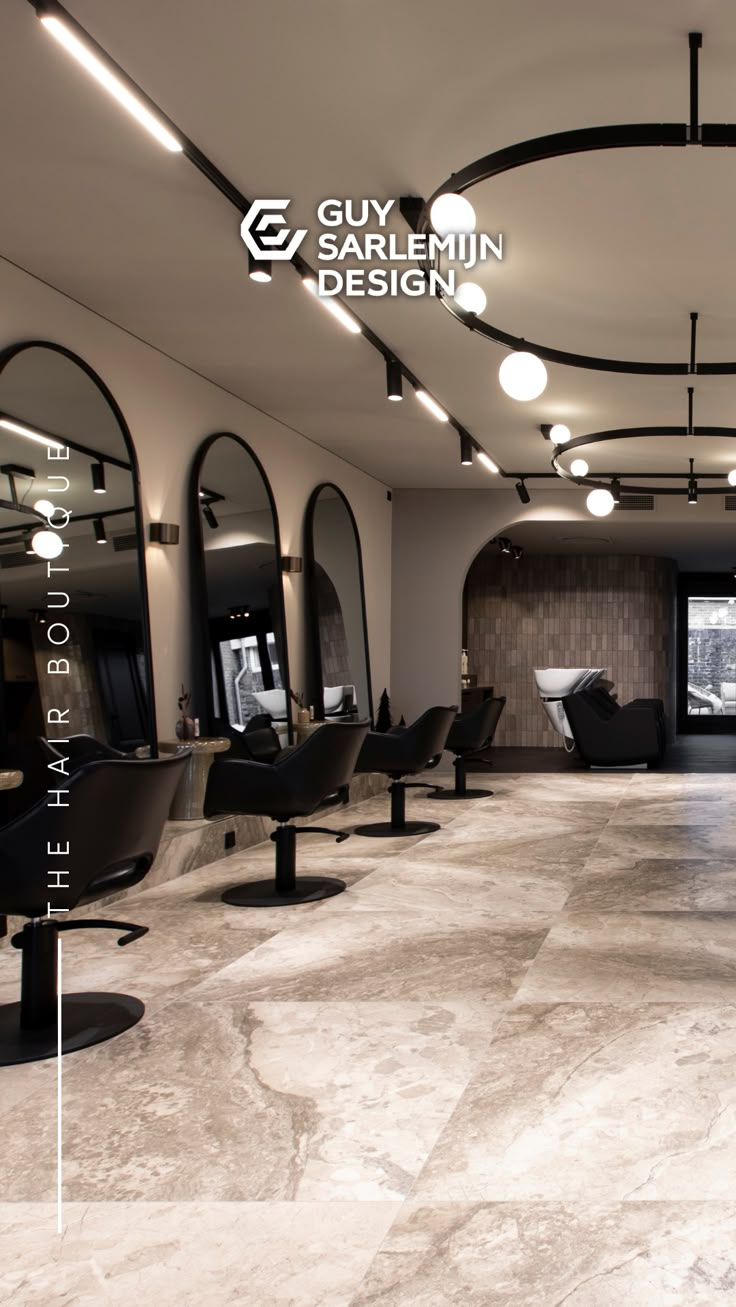 the interior of a hair salon with chairs and mirrors