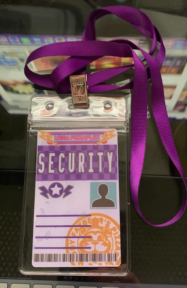 an id badge is attached to a purple lanyard with a ribbon around the neck