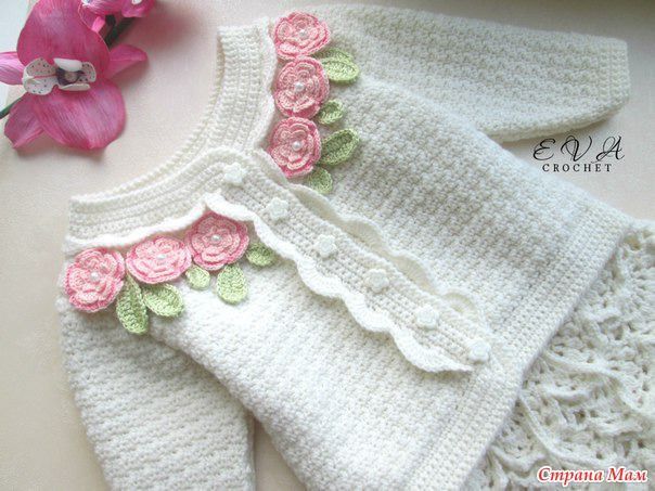 the sweater is knitted with flowers on it and has been made to look like roses