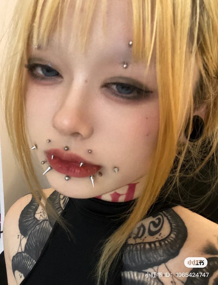 a woman with piercings on her face and chest