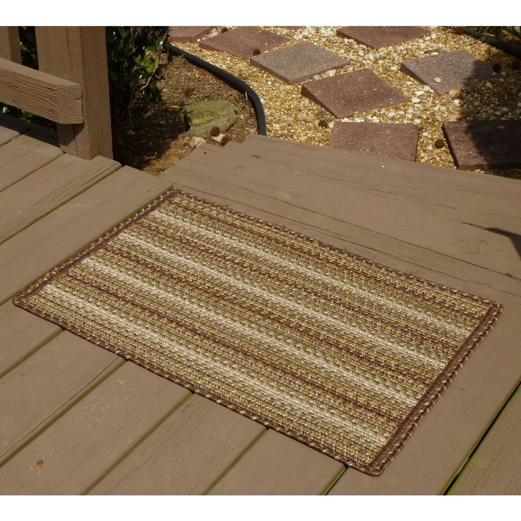 the rug is on the wooden deck outside