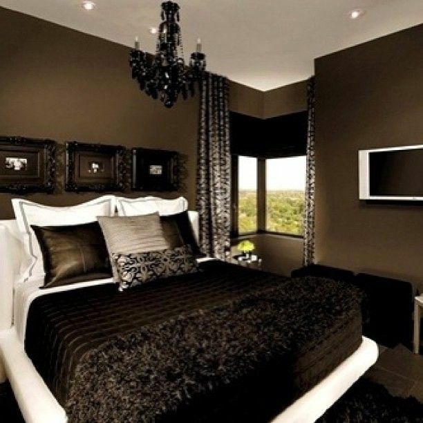 a bedroom with a large bed and chandelier