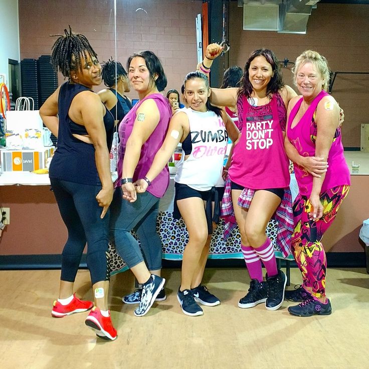 a group of young women standing next to each other in front of a counter top