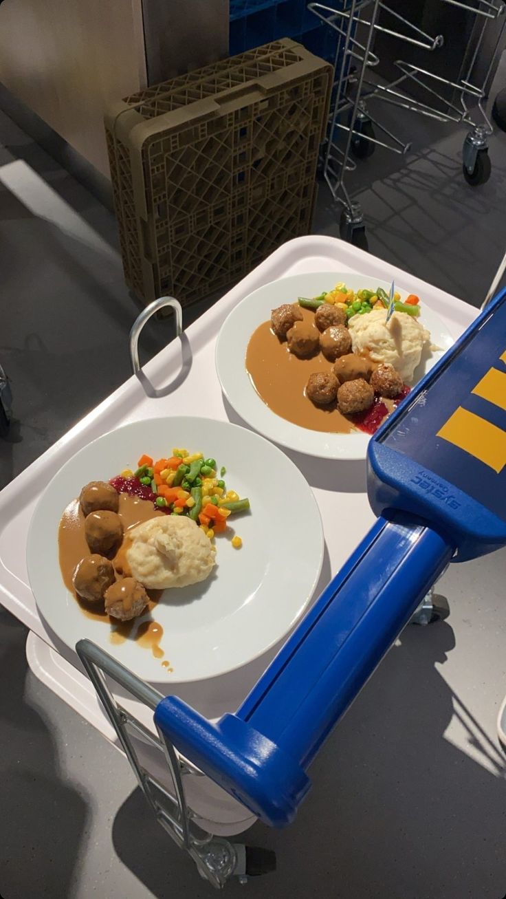 two plates with food on them sitting on a table in front of a shopping cart