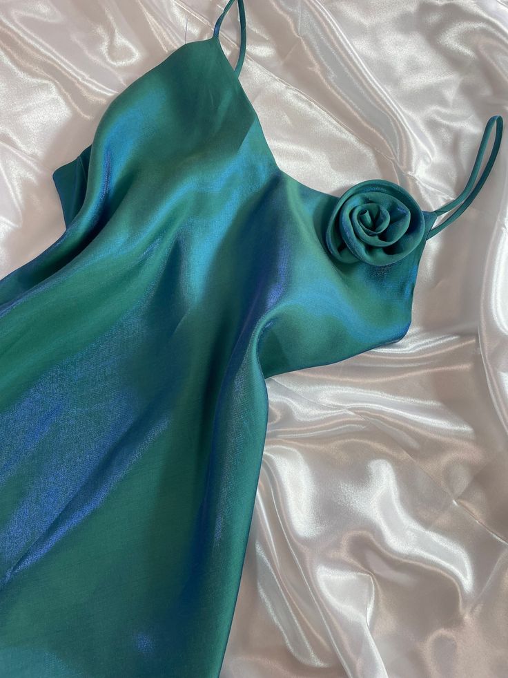 Step into enchantment with this French vintage iridescent blue-green maxi formal dress! Crafted to captivate, this gown boasts a mesmerizing color-changing effect that shimmers with every angle and lighting variation, as showcased in the accompanying video. The exquisite vintage condition of this piece ensures timeless elegance for any occasion. Its flowing silhouette and rich hues evoke a sense of grace and sophistication, perfect for soirées, galas, proms or any special event where you wish to Turquoise Dress Aesthetic, Green Bias Cut Maxi Dress For Party, Formal Green Bias Cut Maxi Dress, Green Floor-length Bias Cut Evening Dress, Green Evening Dress With Bias Cut, Green Bias Cut Evening Dress, Elegant Iridescent Dress For Evening, Green Bias Cut Maxi Dress For Wedding, Green Bias Cut Dress For Prom