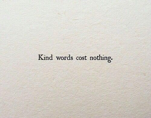 the words kind words cost nothing written in black ink on a white sheet of paper