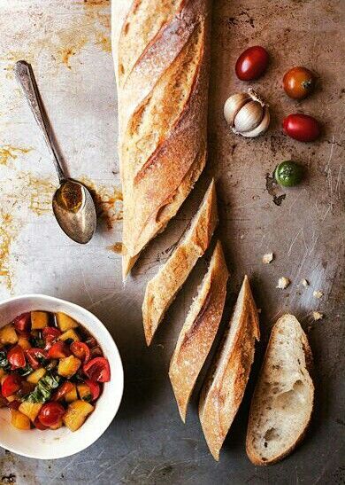 bread, tomatoes and other vegetables on a table