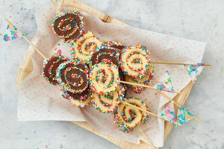 chocolate and sprinkle covered donuts on sticks