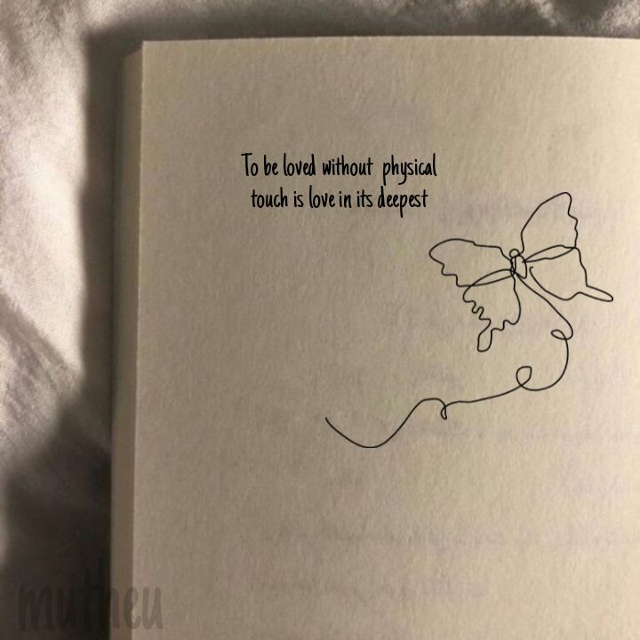 an open book with a drawing of a butterfly on it