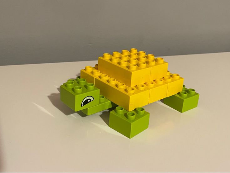 a lego turtle made to look like it's going to build something out of bricks