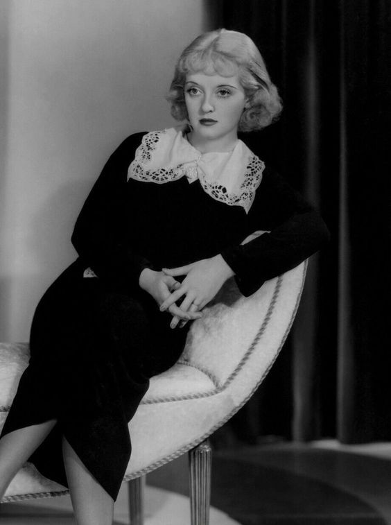 black and white photograph of a woman sitting on a chair