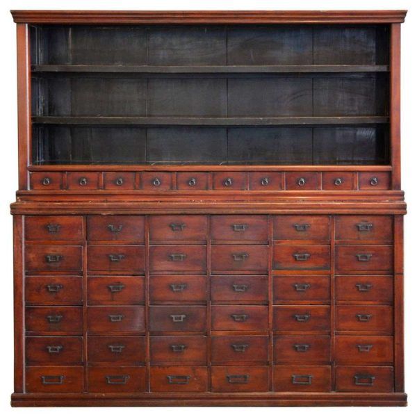 an old wooden dresser with many drawers