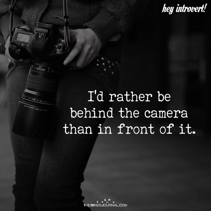 a woman holding a camera with the words i'd rather be behind the camera than in front of it