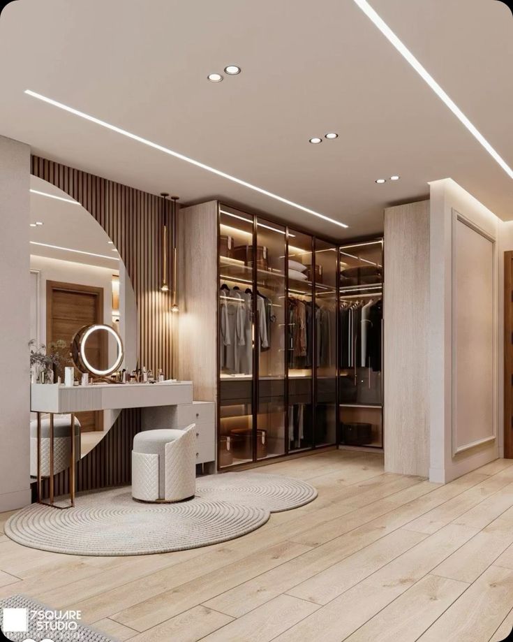 a large walk - in closet with dressing area and mirror on the wall next to it