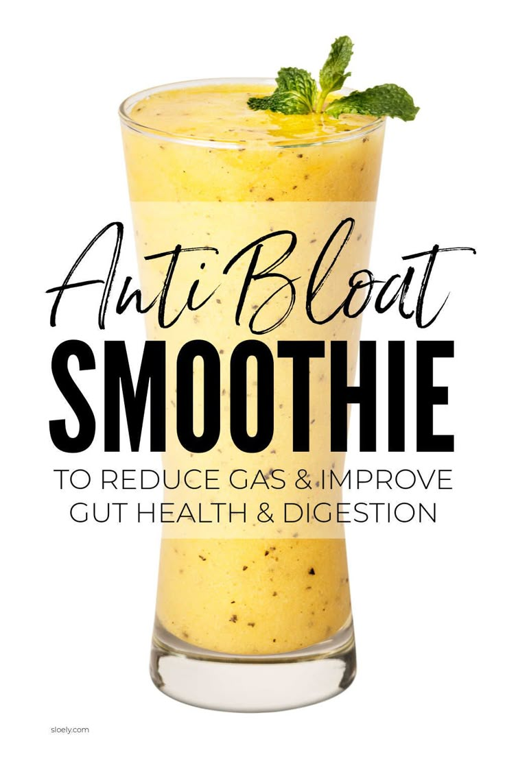 an orange smoothie in a tall glass with mint sprig on top and the words, anti bloat smoothie to reduce gas & improve gut health & digest