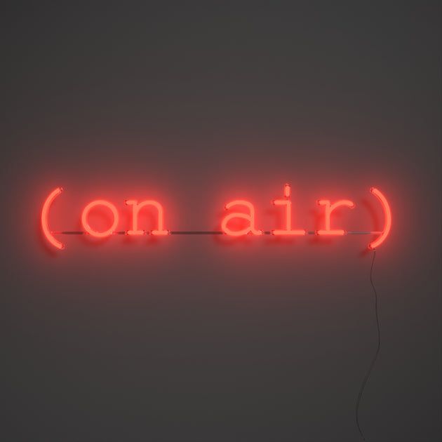 a red neon sign that says on air