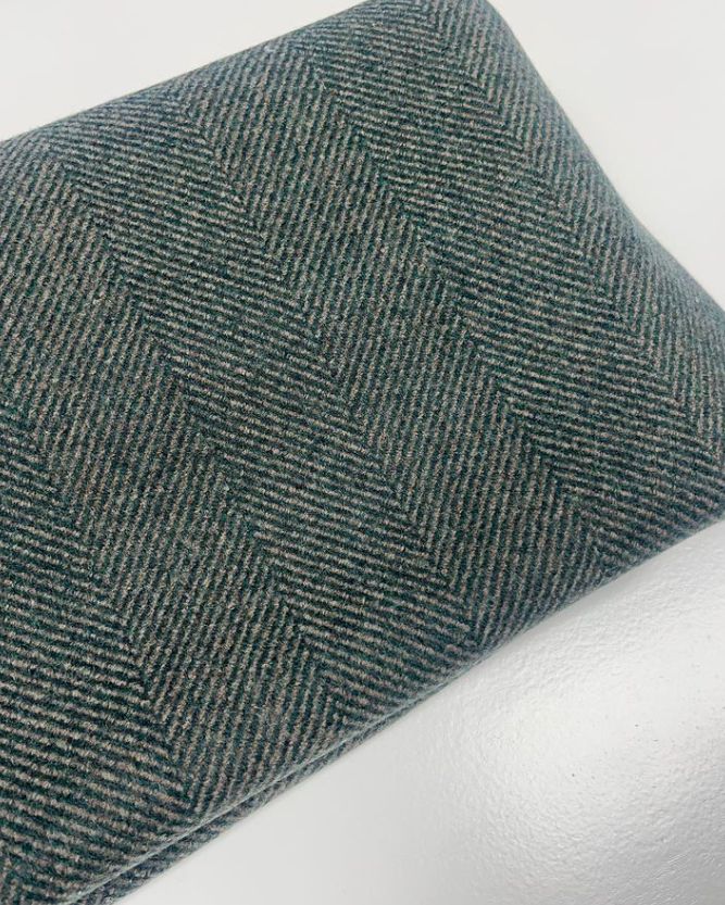 a close up of a green and grey herringbone fabric