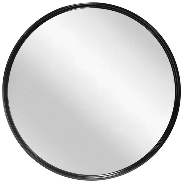 a round mirror on a white background with black trimmings and an oval frame