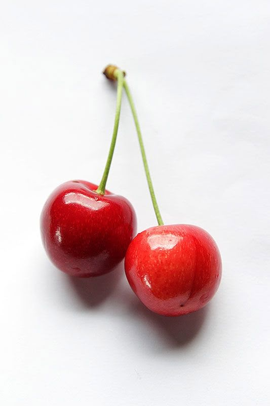 two cherries sitting on top of each other