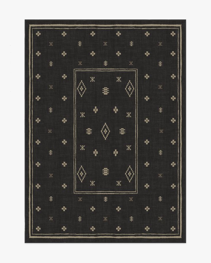 a black rug with white and beige designs on it