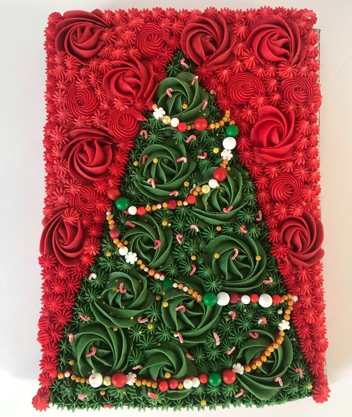 a christmas tree made out of green and red flowers on a white surface with beads