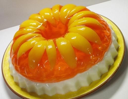 an orange and white cake on a yellow plate