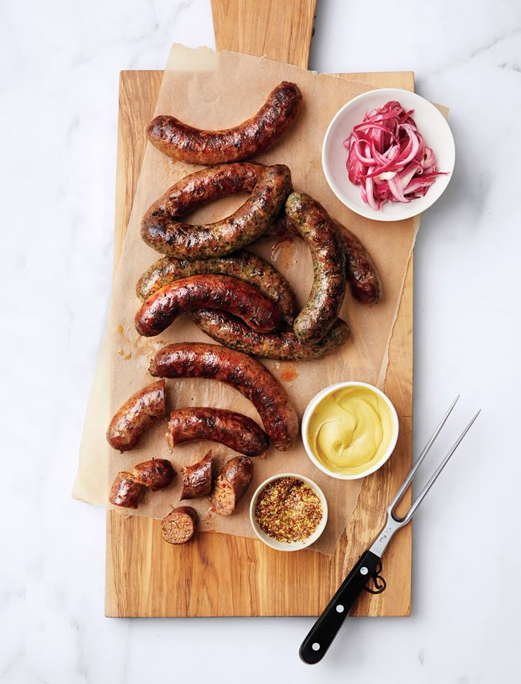 the sausages are ready to be cooked on the cutting board