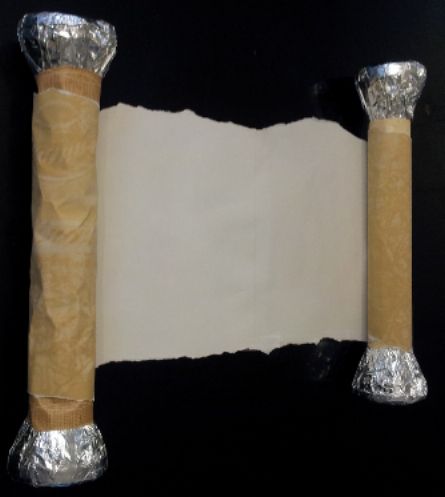 two pieces of foil wrapped in brown paper and one piece of white paper on top of each other