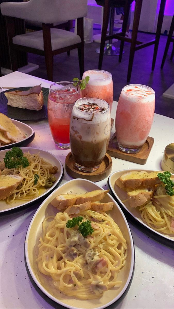 several plates of food and drinks on a table