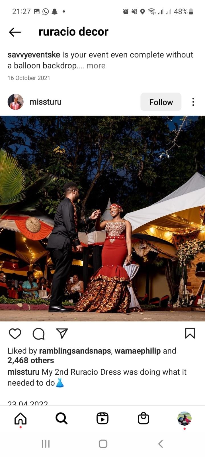 two people standing next to each other in front of a tent with lights on it