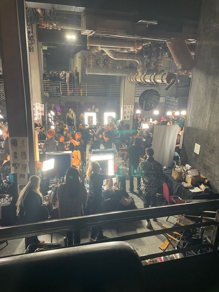 a group of people standing around in a room with computers and lights on the walls