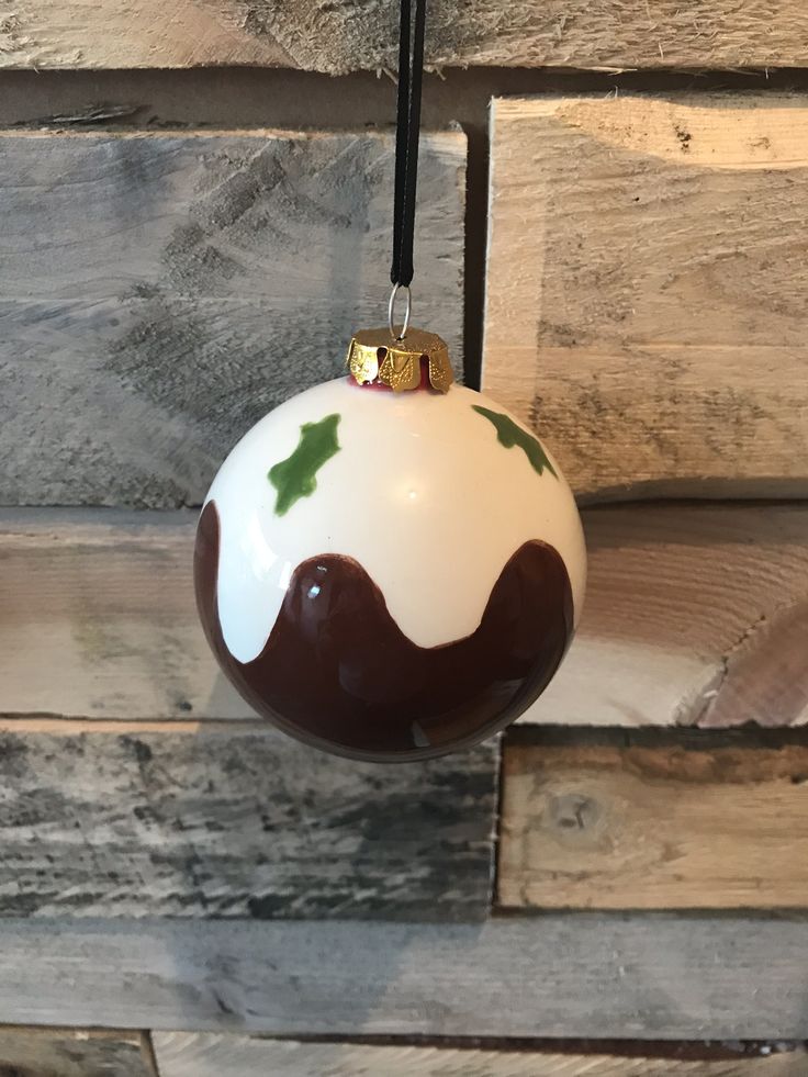 a white and brown ornament hanging from a wooden wall