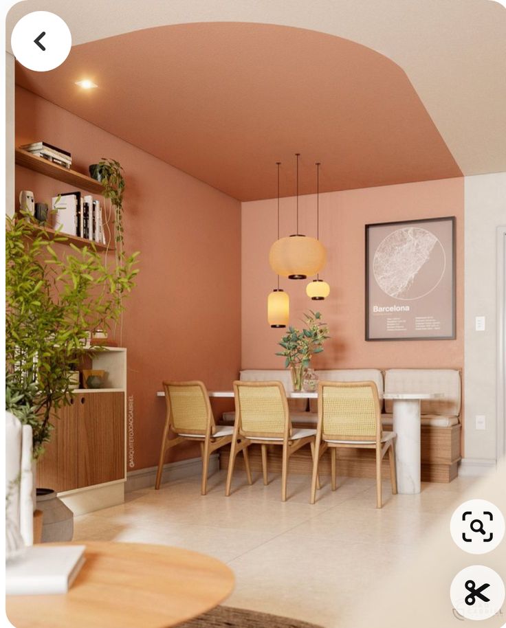 a living room filled with furniture and a dining table next to a plant on top of a hard wood floor