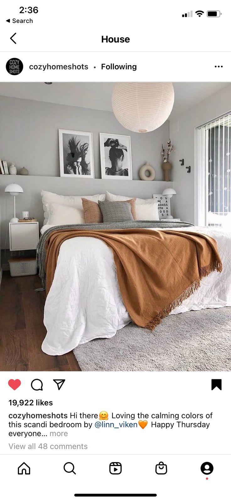 a bed room with a neatly made bed and two pictures on the wall above it