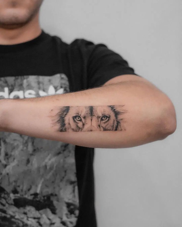 a man with a lion tattoo on his arm