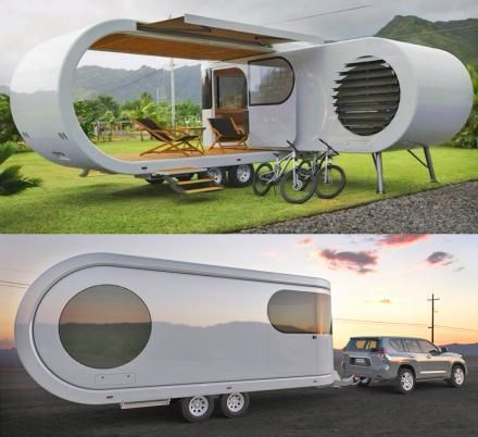 an unusual trailer is parked on the side of the road and it's built into the grass