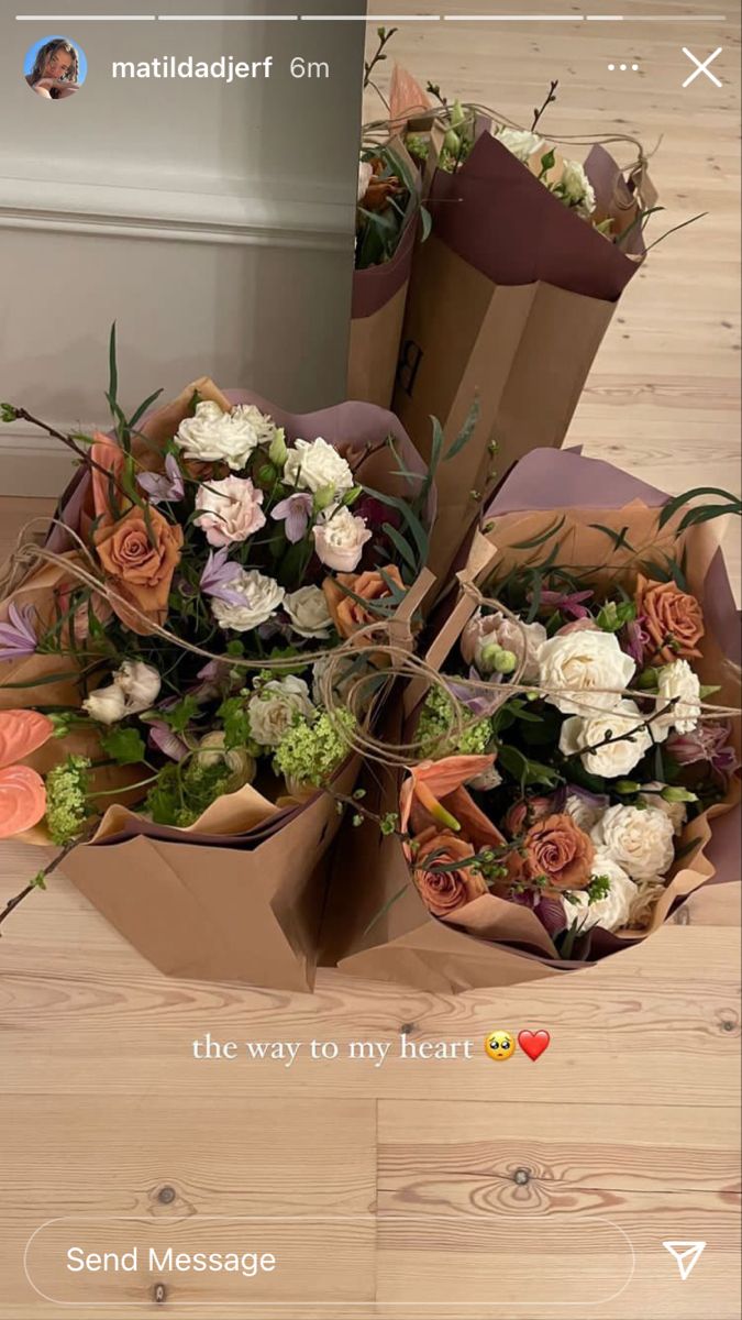 a bouquet of flowers sitting on top of a wooden floor