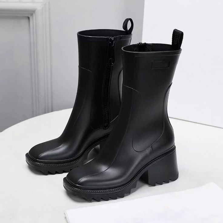 Enjoy rainy days with the Carmela Rubber Boots. This style features shiny rubber, block heel, and sleek square toes. The zip fastening and pull tabs make for easy on and off. These boots look bomb with midi-dresses and your favorite coat on top to channel your inner Parisian. Polyurethane and rubber material. Square toe Ridged rubber sole Low heel Side zip fastening Ankle-length Imported Trendy Rain Boots For Rainy Weather, Women Rain Boots, Female Boots, Half Boots, Rain Shoes, Womens Rain Boots, England Style, Warm Boots, England Fashion