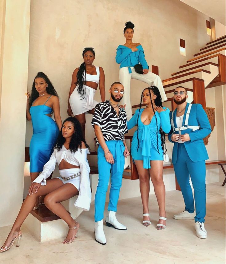 a group of people standing next to each other in front of a stair case and stairs