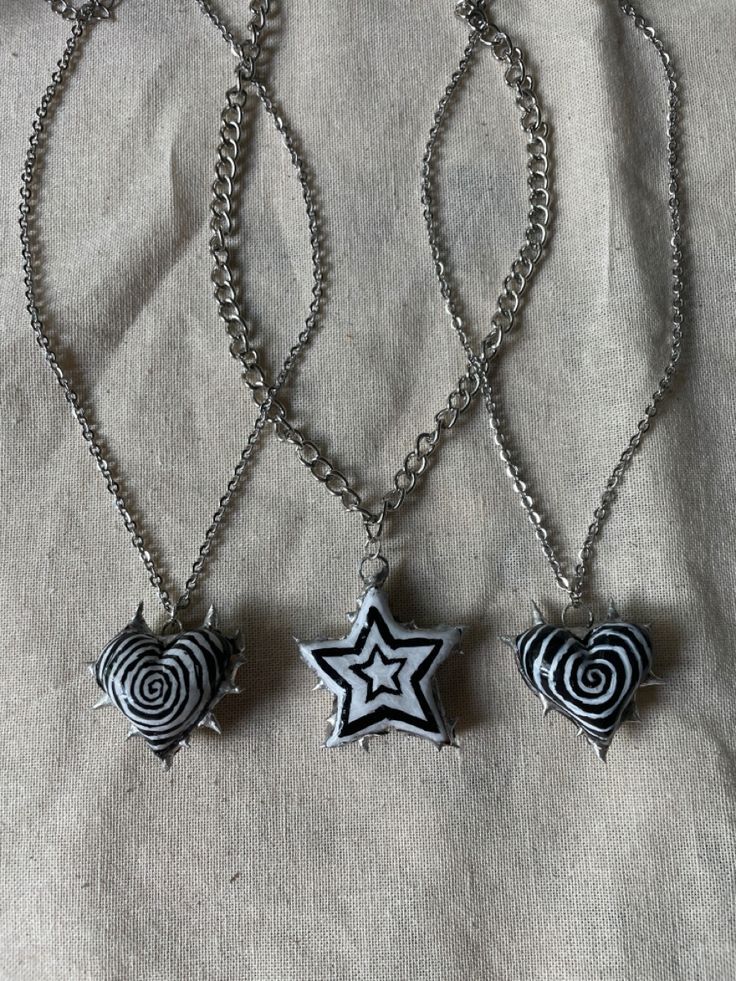 three necklaces with different designs on them