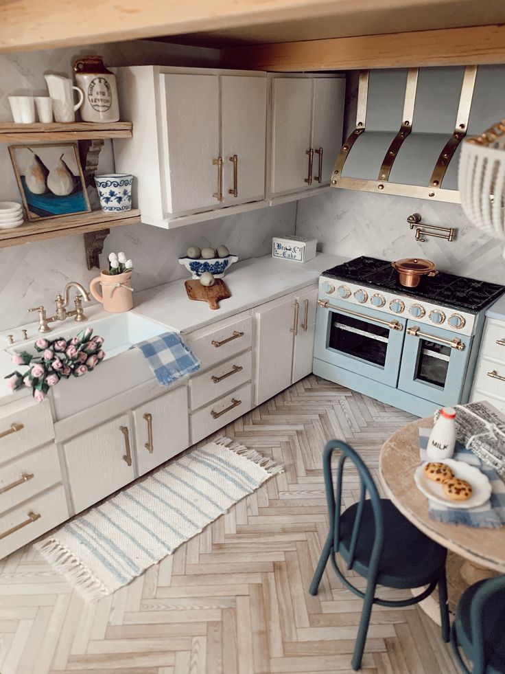 a kitchen with white cabinets and blue appliances