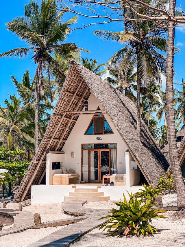 a white house with palm trees in the background