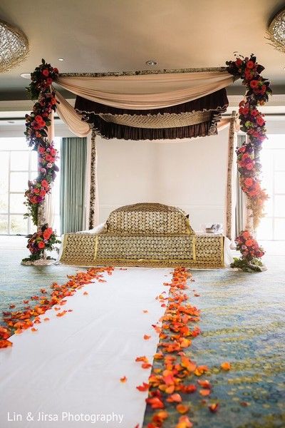 the bed is decorated with flowers and petals