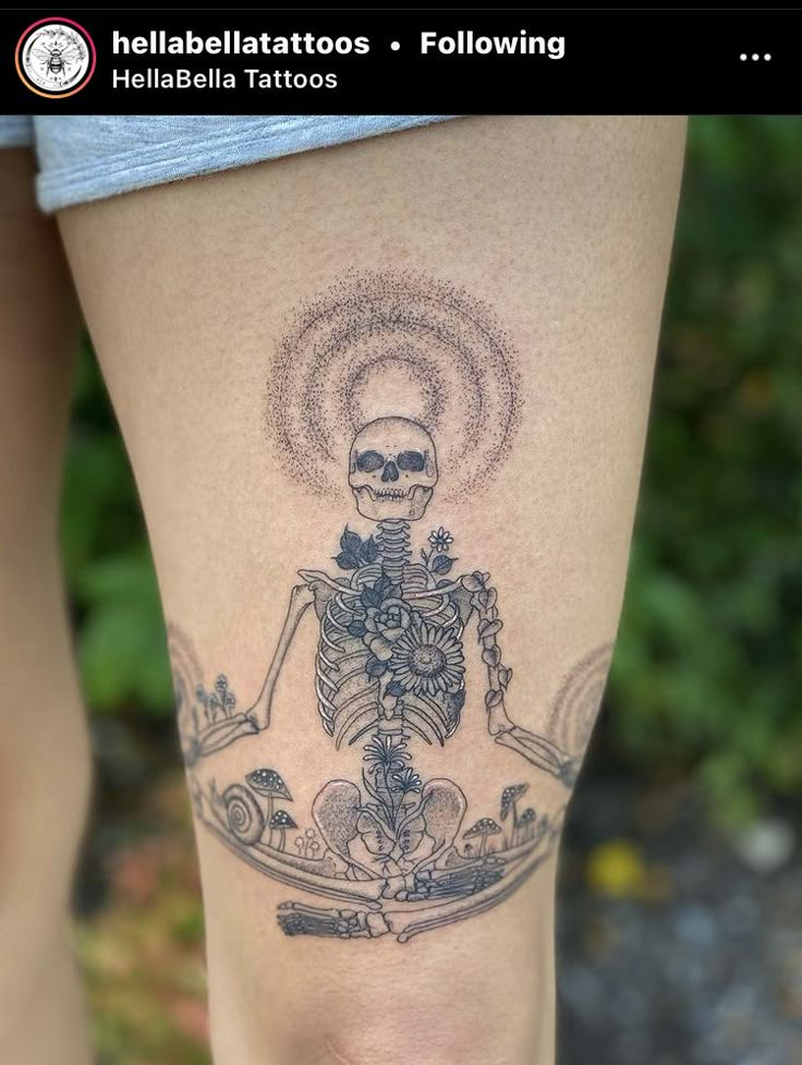 a woman's leg with a skeleton tattoo on it and an image of a skull in the middle