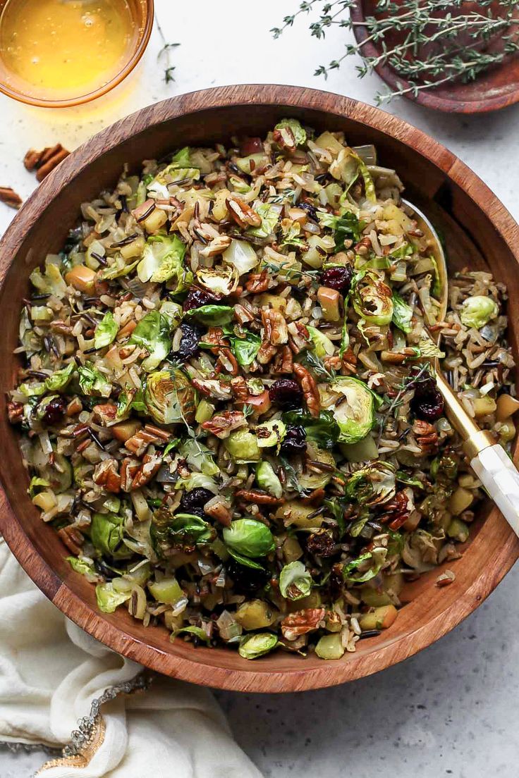 a bowl filled with nuts and brussel sprouts on top of a table