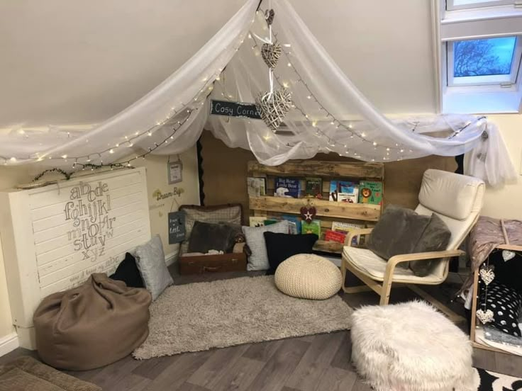 a living room filled with lots of furniture and lights on top of the ceiling above it