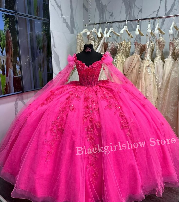 a pink ball gown is on display in a store